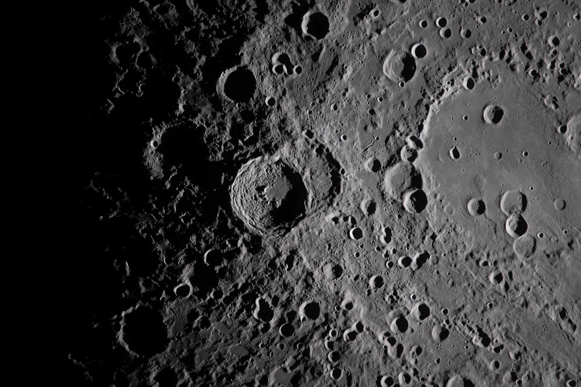 Nærbilde av Vavilov-krateret på randen av Hertzsprung-bassenget, opplyst i lav vinkel